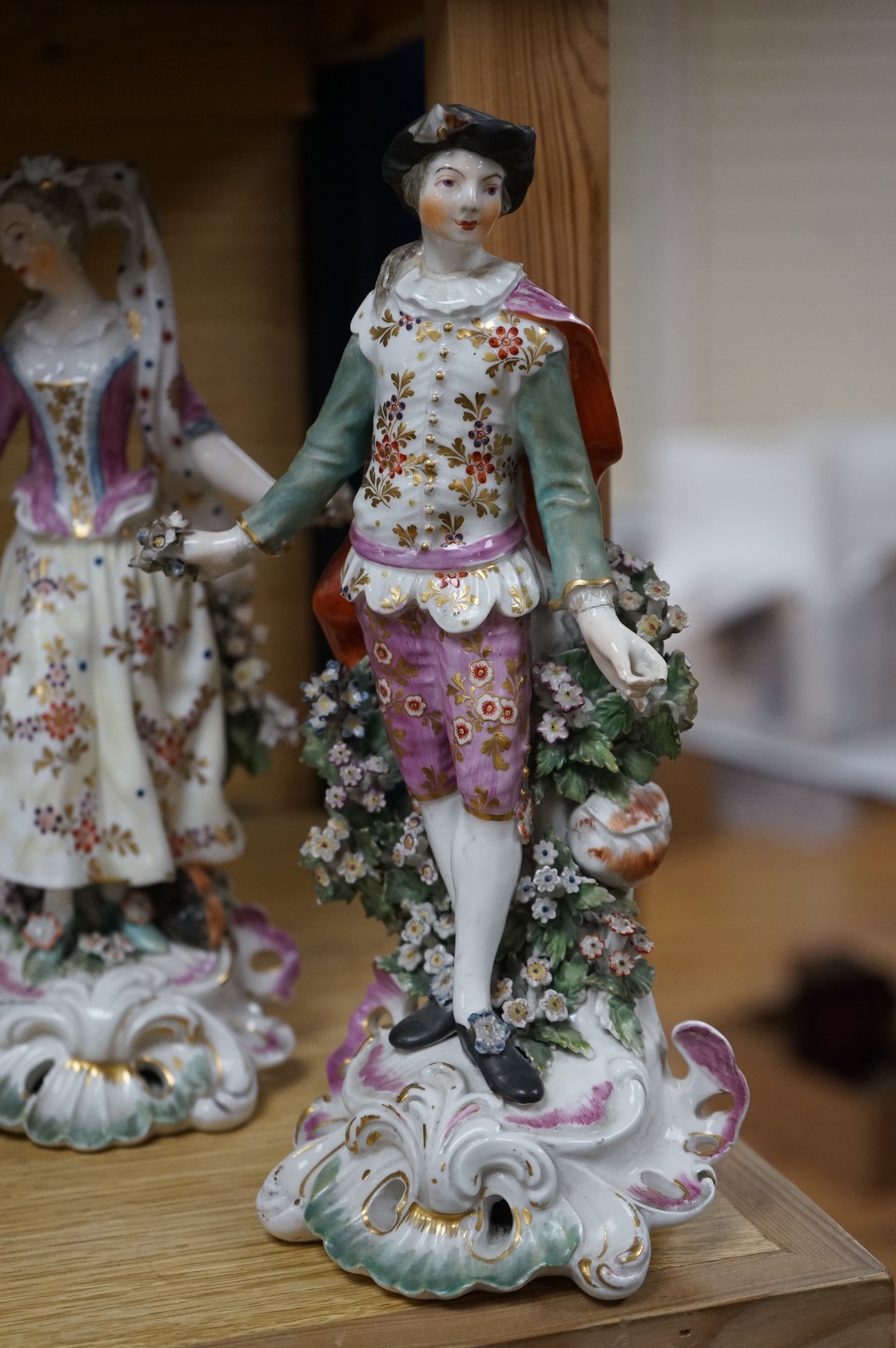 A pair of 18th century Derby porcelain figures of a lady and gentleman, 27cm high